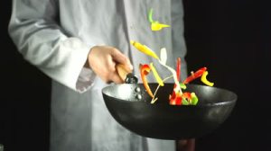 stock-footage-chef-tossing-vegetable-stir-fry-in-a-wok-in-slow-motion
